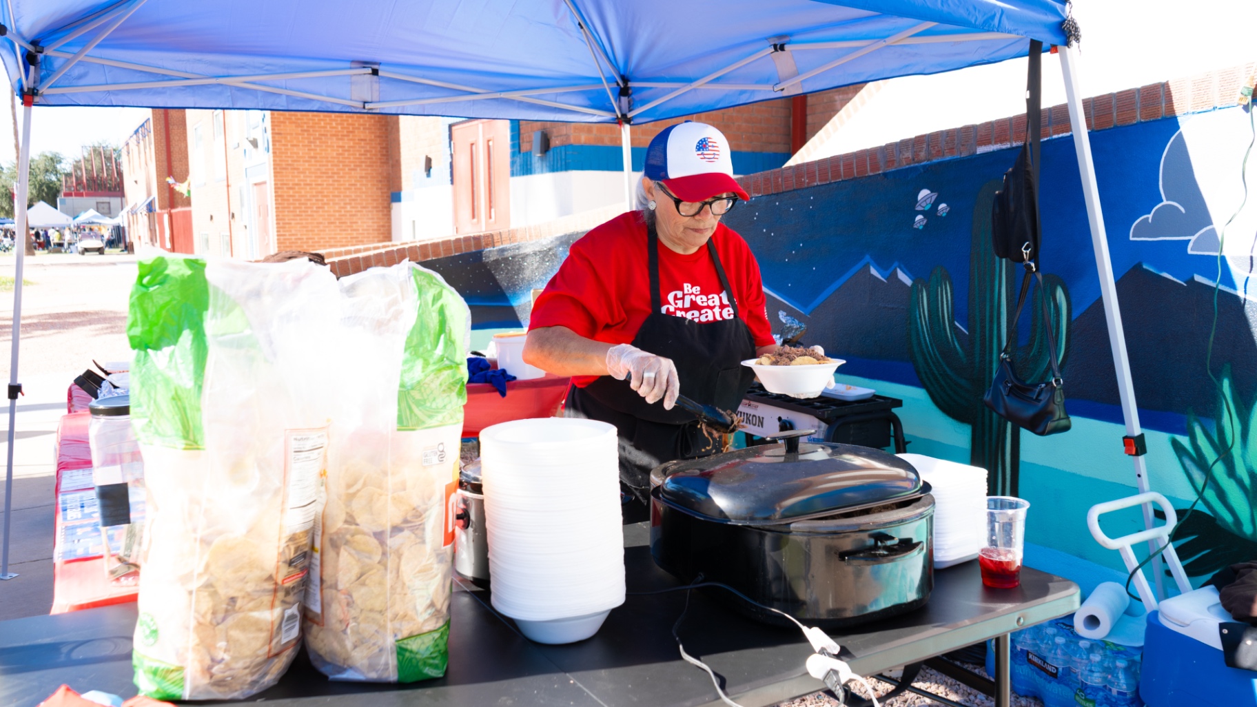 A volunteer serving food at the Veterans Day Cookout