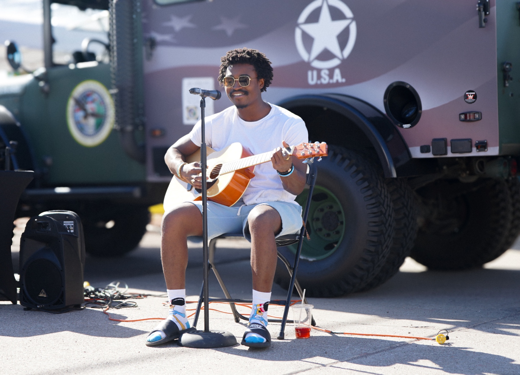A veteran performing live on guitar at the Veterans Day Cookout